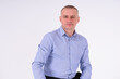 © Galka3250 - A man in a blue shirt and black trousers sits on a stool on a white background