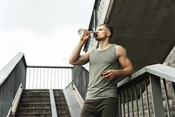 Wall Mural - Muscular man after jogging workout on a city street