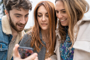 Happy young people using mobile smart phone