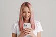 © Drobot Dean - Young european woman smiling while using mobile phone