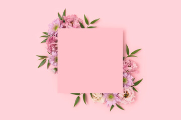 Wall Mural - Empty square paper card with border frame made of eustoma flower on a pink pastel background. Springtime concept.