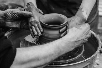 Wall Mural - Potters and child hands. Family working on pottery wheel. Dad and child making ceramic pot together.