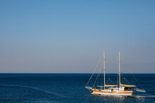 Two-masted White Sailing Yacht In The Deep Blue Sea