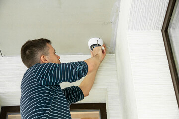 Man installs security camera in private house under construction