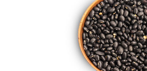 Black beans in wooden bowl on white background, top view, copy space