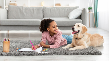 Canvas Print - Young afro girl drawing with dog at home