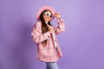 Wall Mural - Photo of little lady beaming smile look empty space wear sunglass pink hat checkered coat isolated violet color background