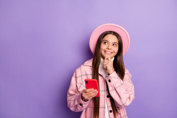 Sticker - Portrait of attractive cheerful curious girl using gadget creating new post smm copy space isolated over bright violet purple color background