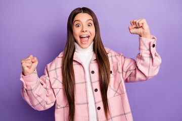 Wall Mural - Portrait of attractive lucky satisfied cheerful girl wearing checked coat rejoicing isolated over bright violet purple color background