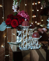 Wall Mural - Vertical shot of dessert and flowers on the stands as a celebration decors