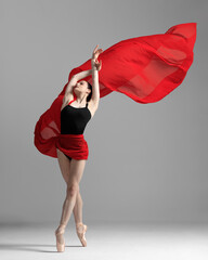 Wall Mural - Young beautiful skinny ballerina is posing in studio