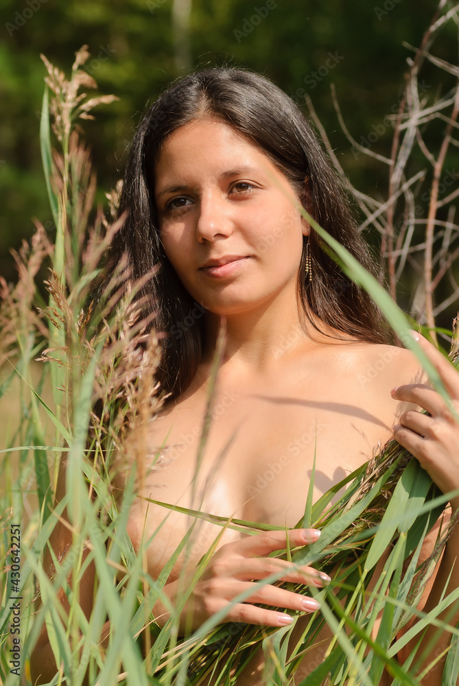 Pretty nude woman relaxing on meadow Stock Photo | Adobe Stock