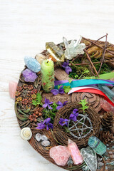 Wall Mural - Wiccan altar for Beltane sabbath. spring pagan festive ritual. wheel of the year with colorful ribbons, gemstones, flowers, pentagram, candle - symbol of Beltane celtic holiday, spring season. 