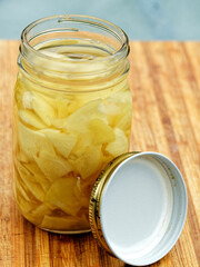 Sliced ginger pickling in the glass jar, close-up