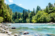 Mountain river in the endless mountains of the North Caucasus. A bright sunny day. Blue sky. Mountains and coniferous forest 