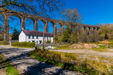 The Victorian railway viaduct stretches across the valley under a blue sky at Cynghordy, Carmarthenshire, South Wales on a sunny day