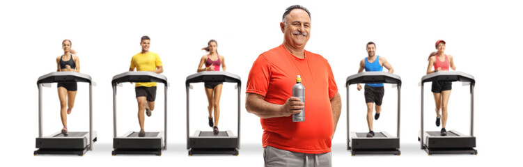 Poster - Mature man in sports clothing holding a bottle and people running on treadmills