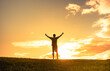 Feeling positive and happiness. Young man standing facing the sunrise with thumbs up to the sky. 