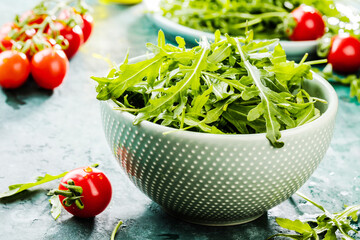 close-up view of fresh salad with tomatoes and arugula on table