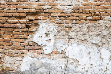 peeling wall texture with exposed brick old masonry