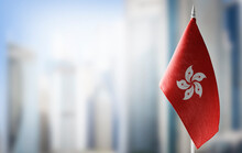 A Small Flag Of Hong Kong On The Background Of A Blurred Background