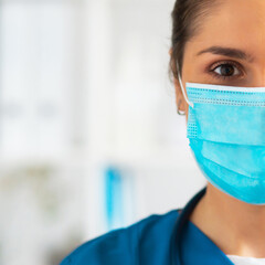 Professional medical doctor working in hospital office, Portrait of young and attractive female physician in protective mask.