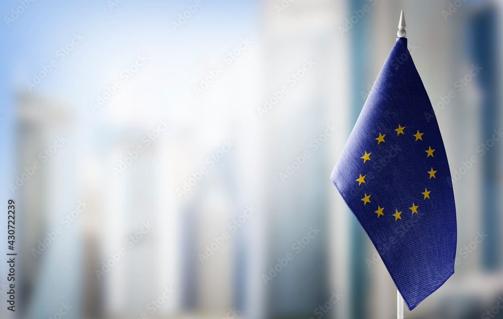 Small national flags of the European Union on a light blurry background - obrazy, fototapety, plakaty 