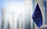 Fototapeta  - Small national flags of the European Union on a light blurry background