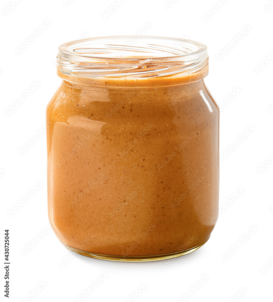 Jar with tasty peanut butter on white background