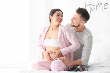 Wall Mural - Beautiful pregnant couple at home