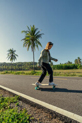 Yougn Asian Women Playing Surfskate on a road, in summer season