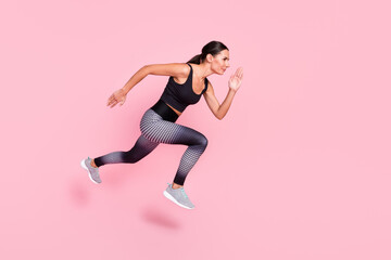 Poster - Full length profile side photo of young sporty woman go walk run fast jump cross competition isolated over pastel color background