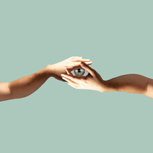 Modern Design, Contemporary Art Collage. Inspiration, Idea, Trendy Urban Magazine Style. Two Hands Holding Eye Pupil On Pastel Green Background.