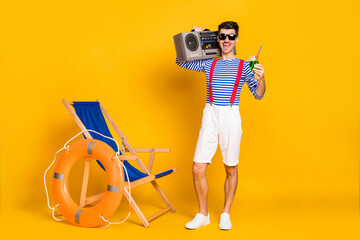 Sticker - Full size photo of handsome brunette man hold boombox cocktail beach wear sailor outfit isolated on yellow color background