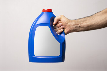 Poster - Male hand holding a blue kitchen detergent bottle