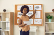 © Studio Romantic - Young business lady, mentor or company marketing manager making presentation using financial data materials pinned on office bulletin board, training employees, explaining strategy, sharing expertise