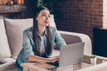 Wall Mural - Photo of dreamy bored young woman sit sofa work from home look away laptop indoors inside house flat