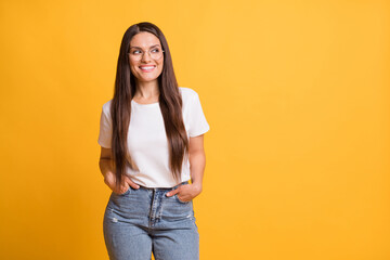 Canvas Print - Photo of attractive cheerful lady look stand empty space hold hands pockets good mood isolated on yellow color background