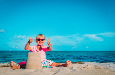 Wall Mural - cute happy girl play with sand on beach