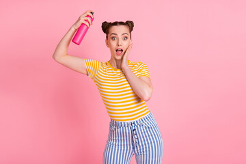 Wall Mural - Photo of impressed nice brunette lady hold spray wear t-shirt pants isolated on pink background