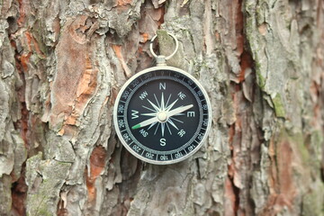 Classic navigation compass on natural background as symbol of tourism with compass, travel with compass and outdoor activities with compass