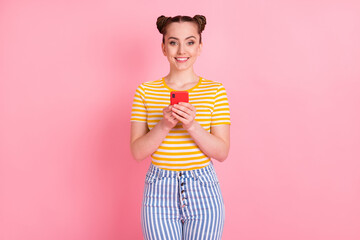 Poster - Photo of charming positive person hands hold phone toothy smile look camera isolated on pink color background