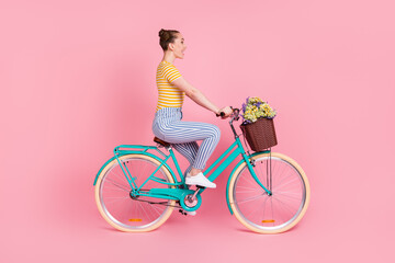 Canvas Print - Full size profile photo of optimistic nice brunette ride bicycle wear t-shirt pants isolated on pink background