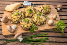 Vegetarian Roasted Portobello Mushrooms Stuffed With Cheese Filling On A Wooden Board