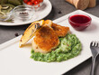 breaded fish fillet with spinach puree garnish