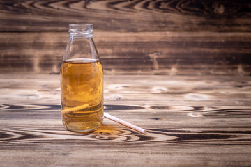 Wall Mural - kombucha cocktail bottle on wooden background