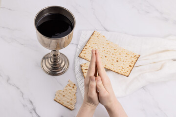 Wall Mural - holy communion chalice with wine and bread. Lord's supper and hands folded in prayer