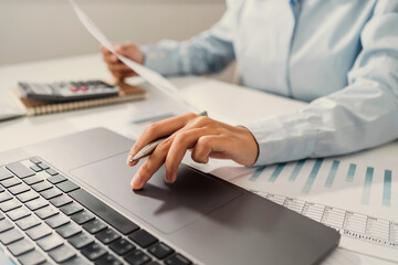 Fototapete - woman accountant use calculator and computer with holding pen on desk in office. finance and account