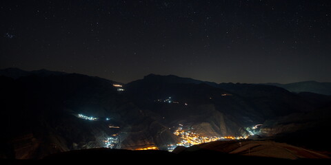 Wall Mural - Russia. North-Eastern Caucasus. Republic of Dagestan. View of the night city of Agwali from the high-altitude sports camp.