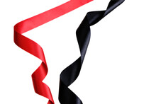 Red And Black Ribbon Twisted In A Spiral On A White Background.